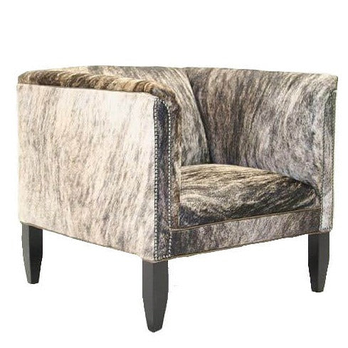 This luxurious western-style square chair features a soft and supple cowhide upholstery, providing a comfortable deep-seated chair with stylish silver studded details. Recline in comfort for an authentic western-inspired experience.
