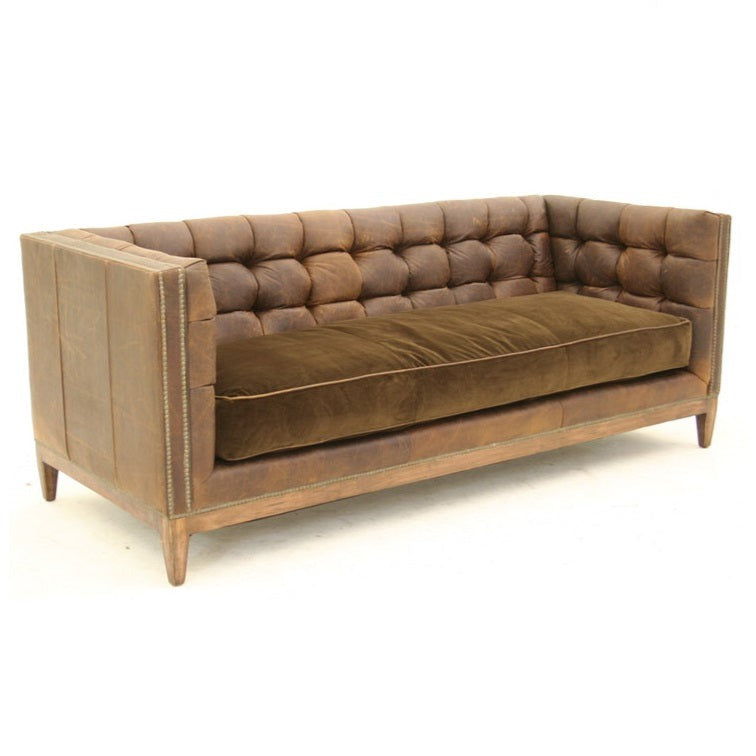 This modern chesterfield tufted leather sofa is a stylish addition to any living room. Boasting signature chesterfield detailing along with a luxurious tufted leather finish and chic nailhead trimmings, this sofa is sure to add sophistication to any space.