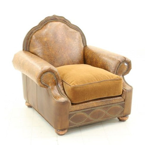 This genuine distressed leather armchair is truly one-of-a-kind. Hand crafted with luxurious materials and traditional western style, it's built to be both comfortable and sturdy with an infinity symbol base and wide arm chair. It also features a wooden arch detail for a timeless, high-end look. Made in the USA.